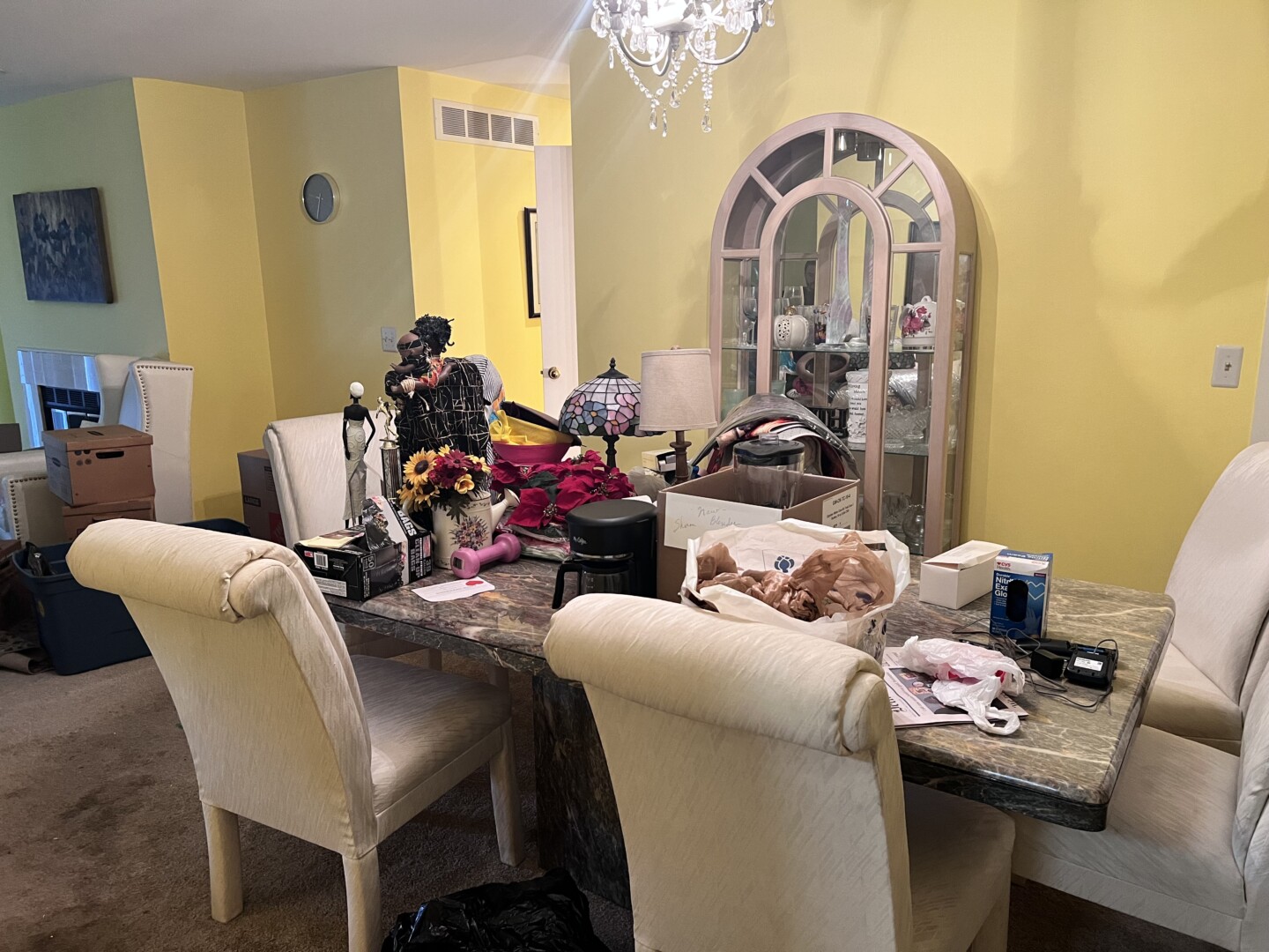 a table of personal items in a home in preparation for holding an estate sale